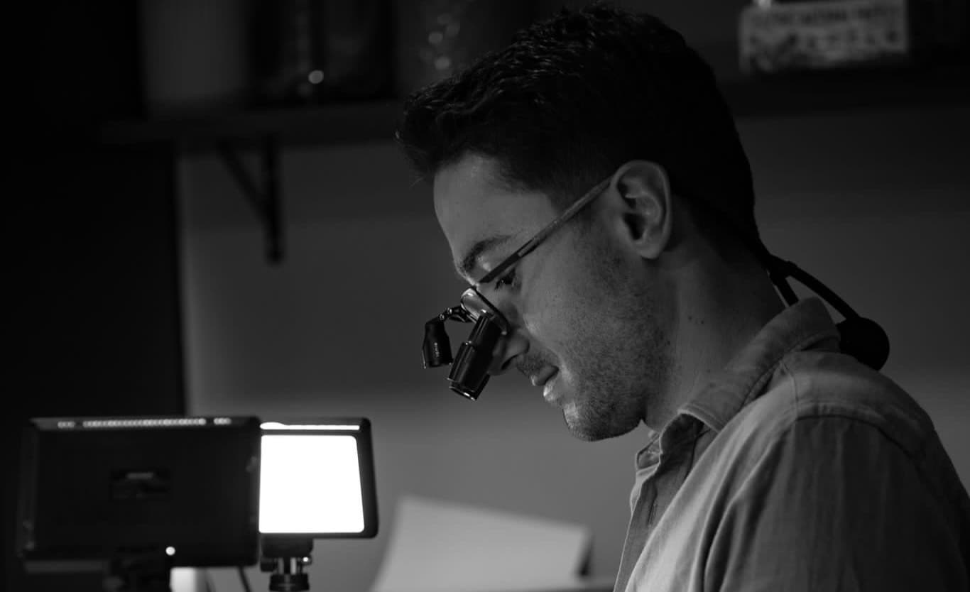 Dr Albert Gajdos wearing dental loupes, working on a composite case